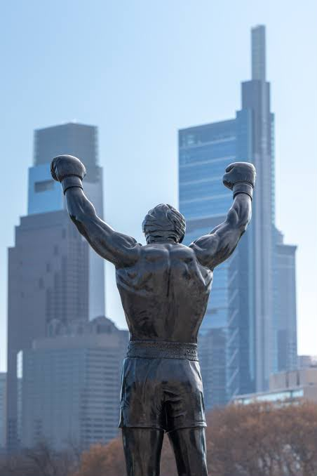 Statue holding a constellation of spheres